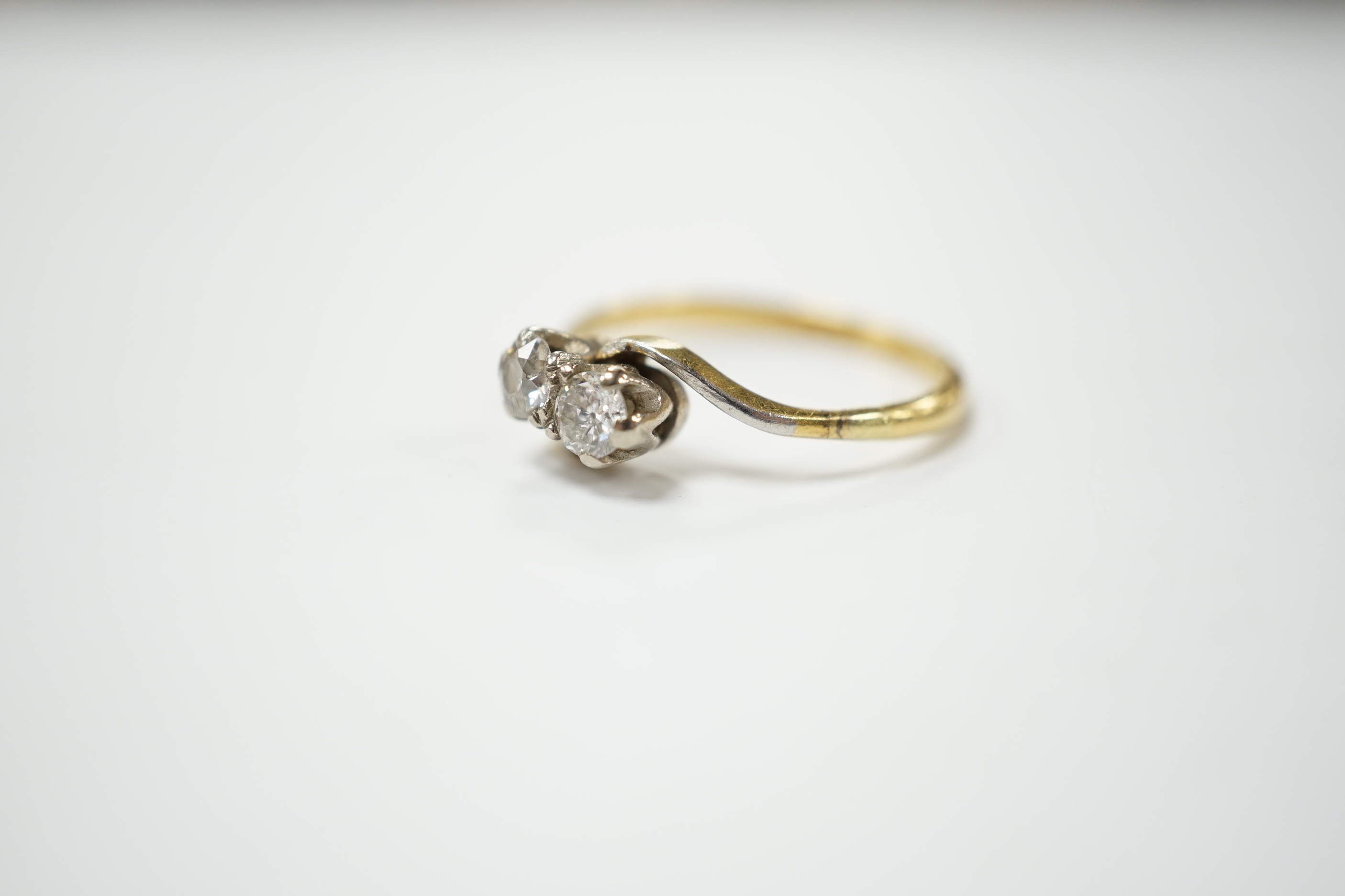 An 18ct gold and platinum two stone diamond ring, size M